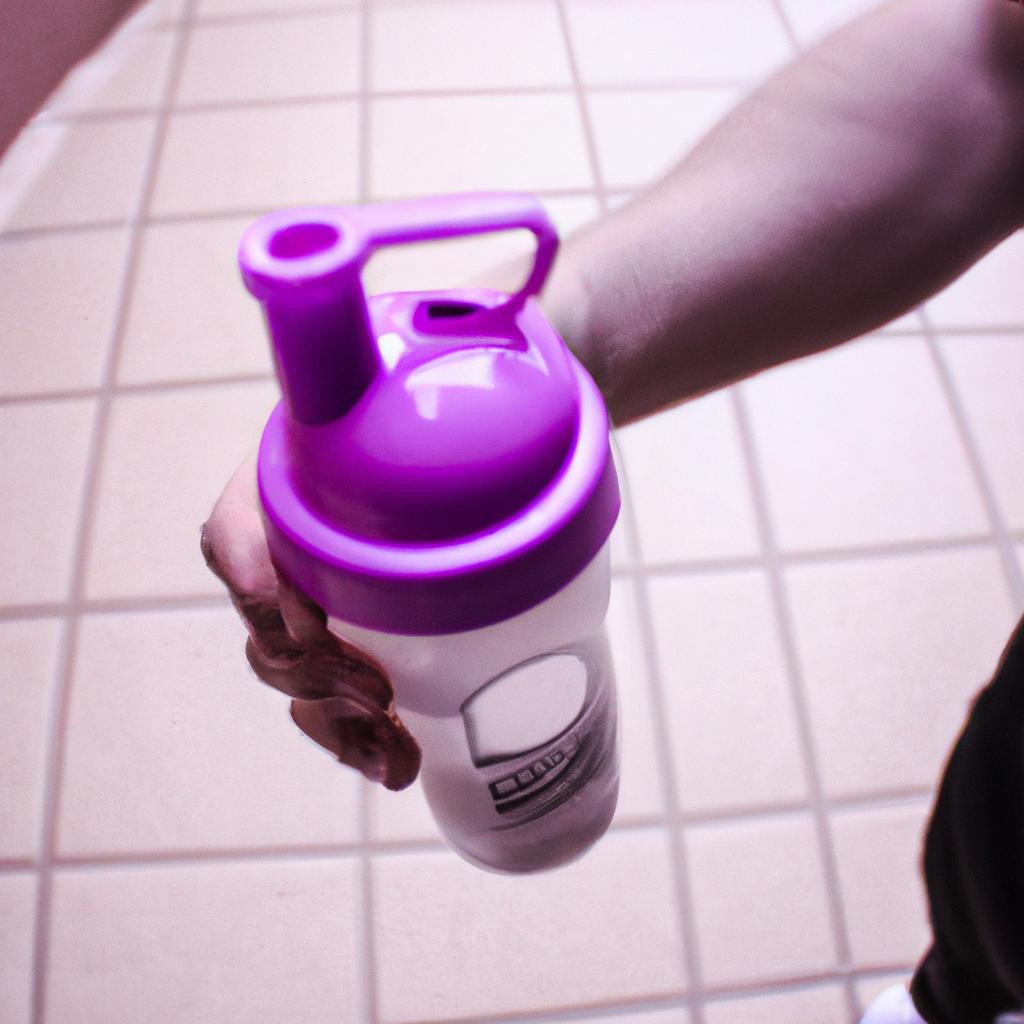 Person holding protein shake bottle